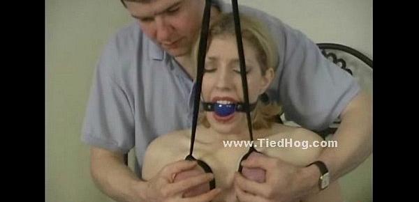  Gagged blonde has her breasts bound in rope while also being forced to cum